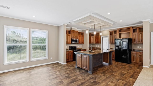 kitchen with dark hardwood / wood-style flooring, pendant lighting, black appliances, and a center island with sink