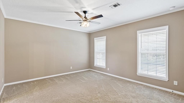 carpeted empty room with ceiling fan and ornamental molding