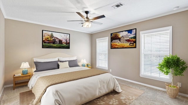 carpeted bedroom with ceiling fan and crown molding