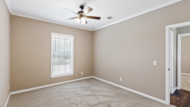 carpeted spare room with a textured ceiling, ceiling fan, and ornamental molding