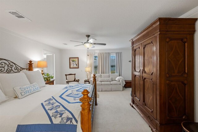 bedroom with ceiling fan, ornamental molding, and light carpet