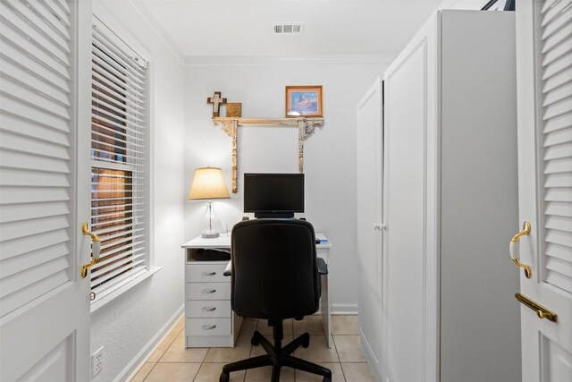 home office featuring light tile patterned floors and crown molding