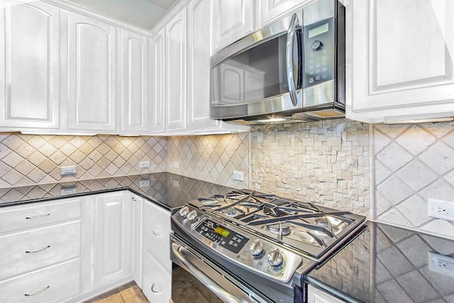 kitchen featuring white cabinetry, appliances with stainless steel finishes, and tasteful backsplash