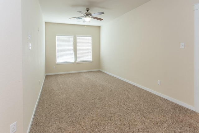 unfurnished room with ceiling fan and carpet