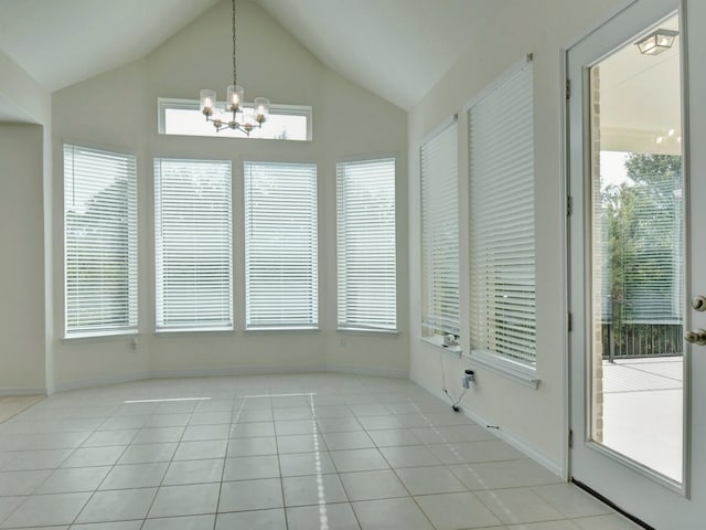 interior space featuring light tile patterned flooring, plenty of natural light, and vaulted ceiling