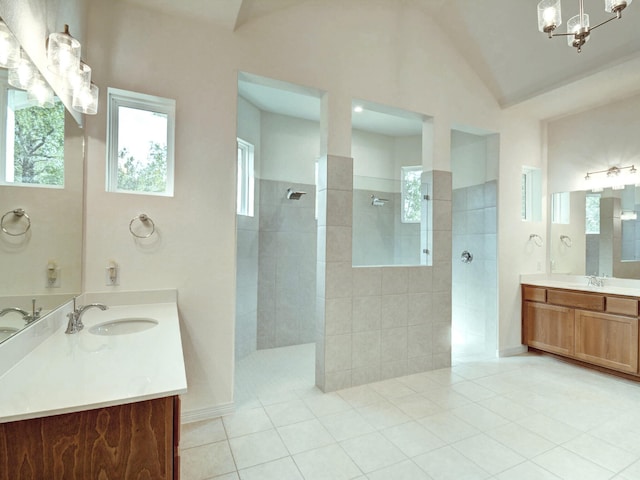 bathroom featuring vanity, a tile shower, a chandelier, and tile patterned flooring