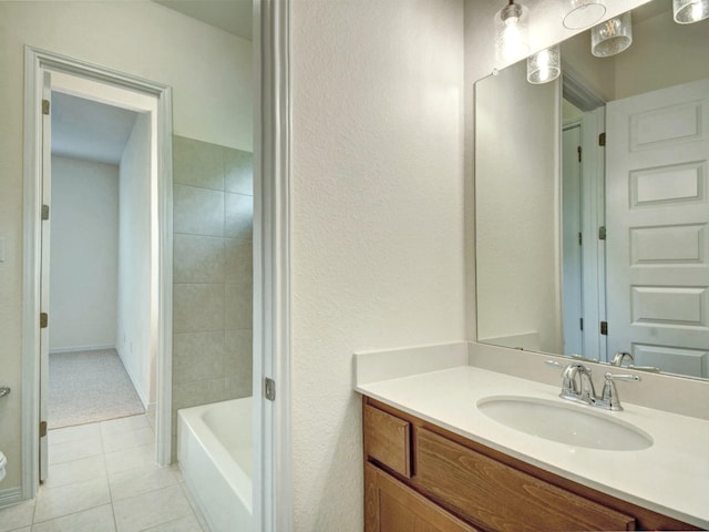 bathroom featuring vanity, a bath, and tile patterned floors