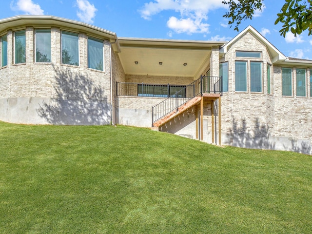 rear view of property featuring a yard