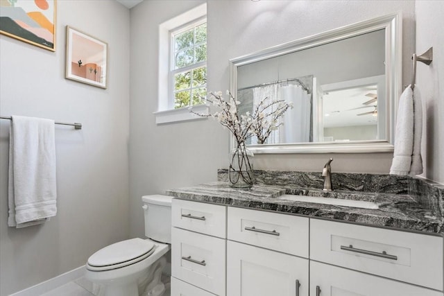 bathroom featuring toilet and vanity