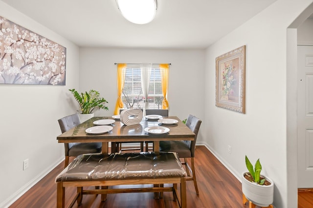 dining area with dark hardwood / wood-style floors