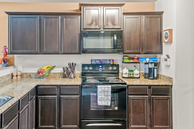 kitchen with black appliances, dark brown cabinetry, and light stone counters