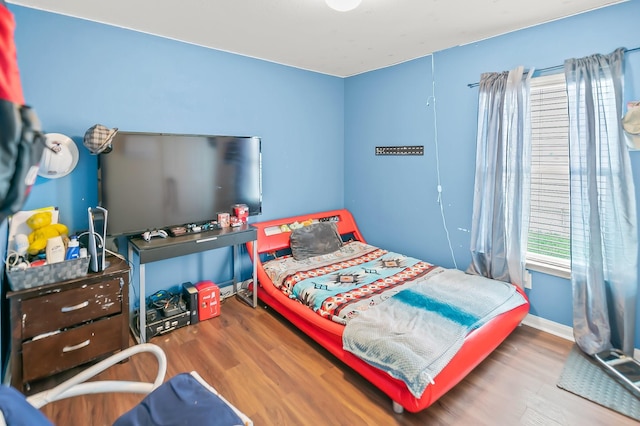 bedroom with hardwood / wood-style floors