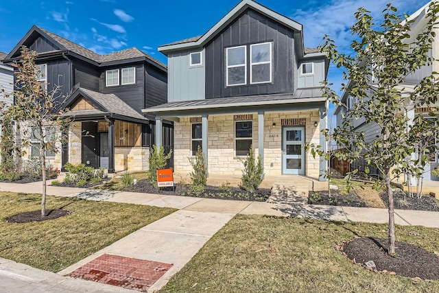 view of front of property with a porch and a front yard