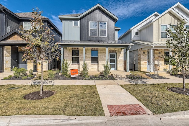 view of front of home with a porch and a front lawn