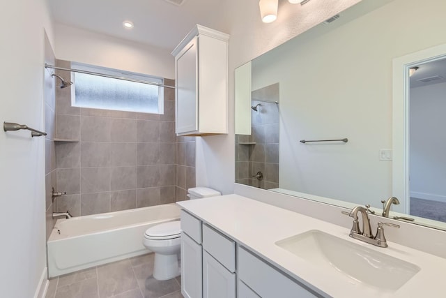 full bathroom with vanity, toilet, tiled shower / bath, and tile patterned floors