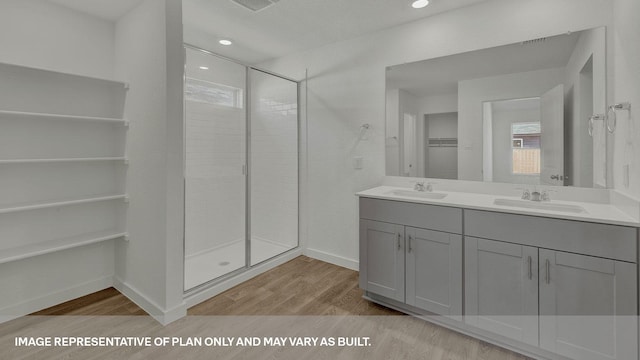 bathroom featuring hardwood / wood-style flooring, an enclosed shower, and vanity