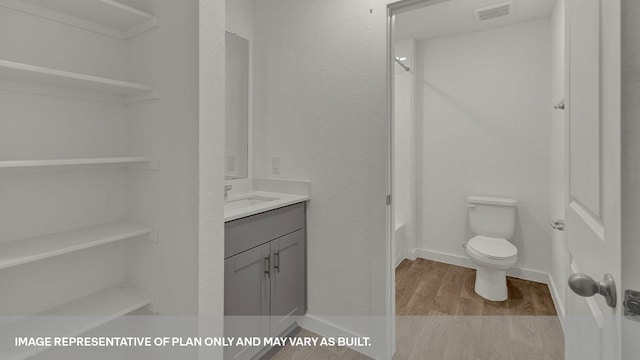 full bathroom featuring  shower combination, hardwood / wood-style flooring, toilet, and vanity