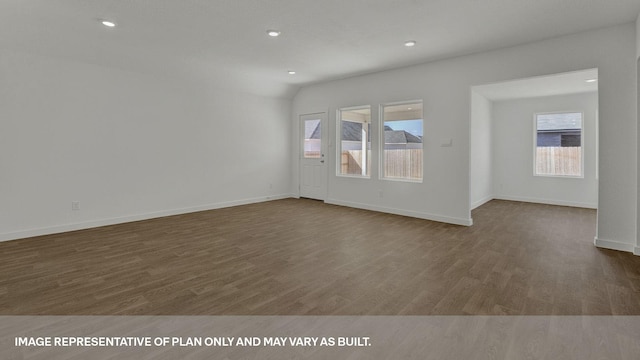 unfurnished room featuring dark hardwood / wood-style flooring and lofted ceiling