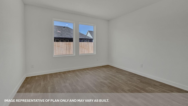 spare room with light hardwood / wood-style flooring