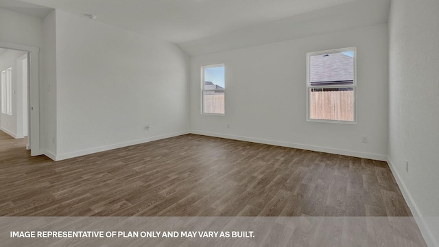 empty room with vaulted ceiling and wood-type flooring