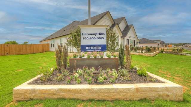 community / neighborhood sign with a yard