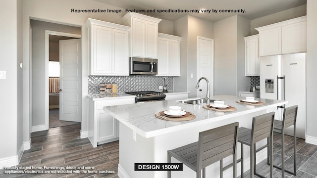 kitchen with white cabinets, a kitchen island with sink, and stainless steel appliances