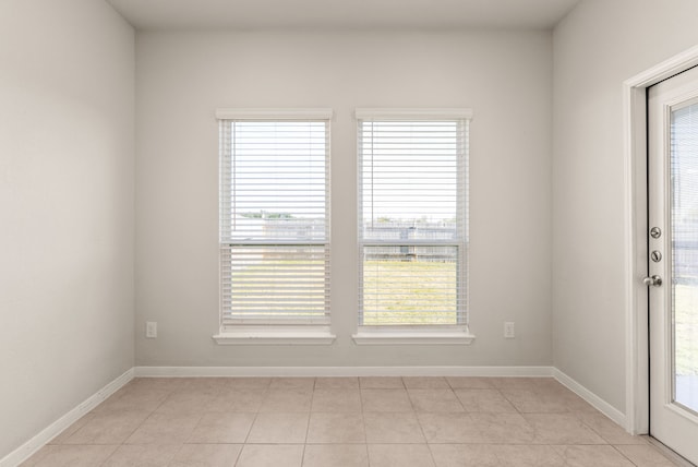 spare room with light tile patterned floors