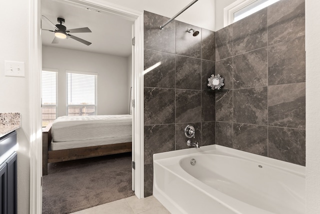 bathroom featuring tiled shower / bath combo, tile patterned flooring, ceiling fan, and vanity