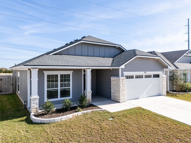 craftsman house with a garage and a front yard