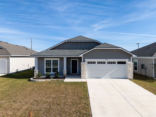 view of front of property with a garage and a front lawn