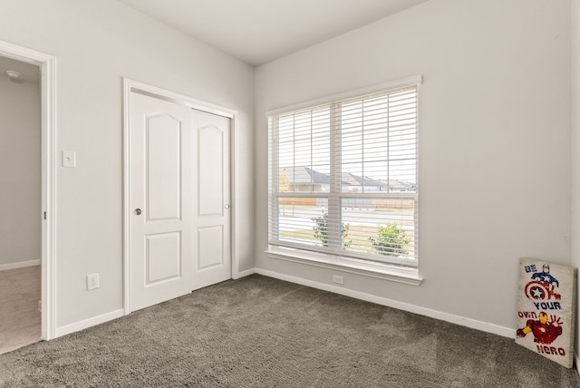 unfurnished bedroom with a closet and carpet flooring