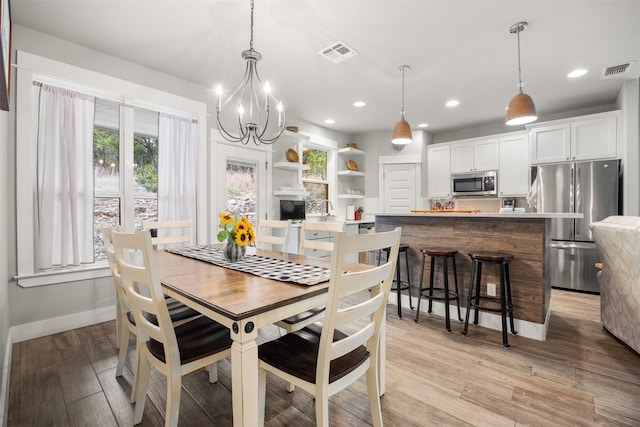 dining space with light hardwood / wood-style flooring