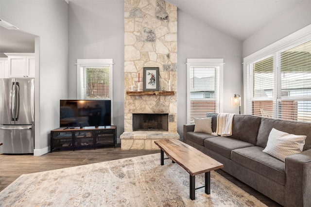 living room with high vaulted ceiling, a healthy amount of sunlight, and wood-type flooring