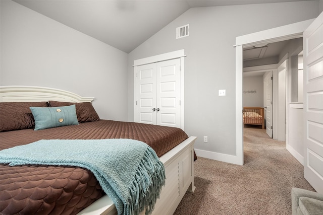 bedroom with a closet, light colored carpet, and lofted ceiling