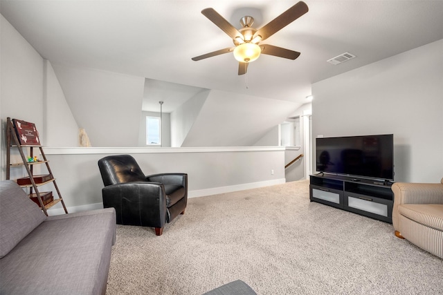 living area featuring ceiling fan, carpet floors, and lofted ceiling