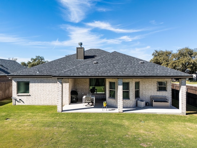 back of house with a patio area and a yard