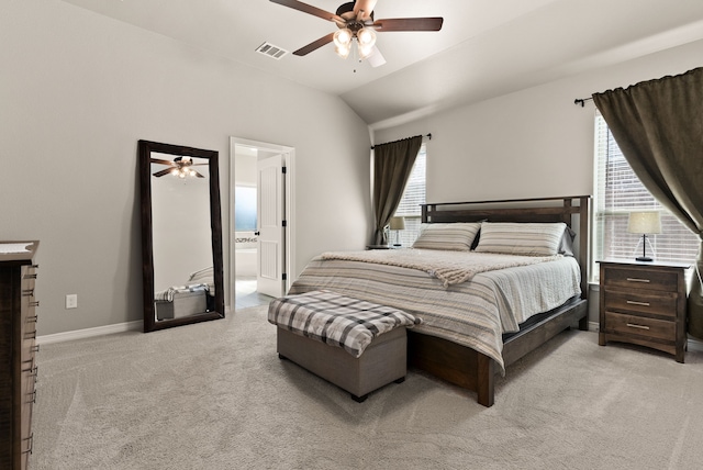 carpeted bedroom with connected bathroom, vaulted ceiling, and ceiling fan