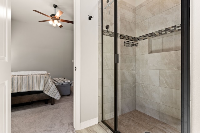 bathroom with a shower with door and ceiling fan