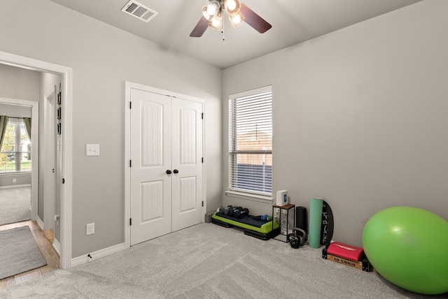 miscellaneous room featuring plenty of natural light, light colored carpet, and ceiling fan