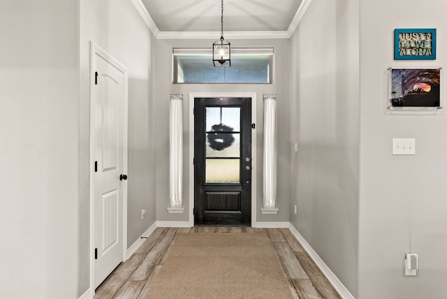 foyer entrance with light hardwood / wood-style flooring and crown molding