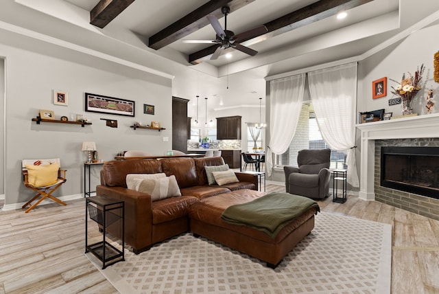 living room with ceiling fan and a premium fireplace