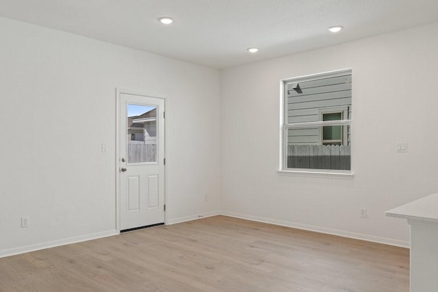 spare room featuring light hardwood / wood-style floors