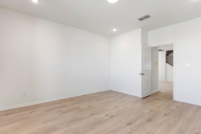 empty room with light hardwood / wood-style flooring