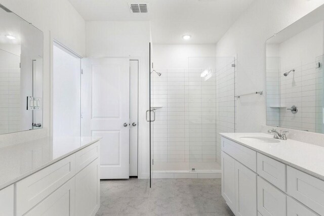 bathroom featuring an enclosed shower and vanity