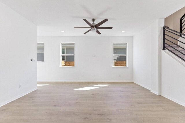 unfurnished room featuring light hardwood / wood-style flooring and ceiling fan