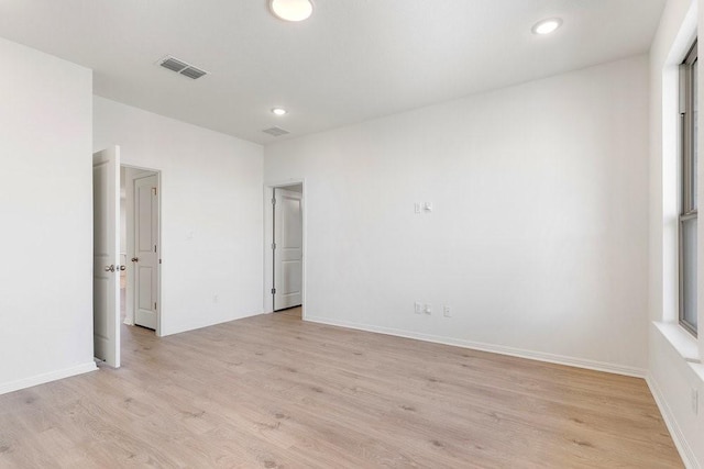 unfurnished room with light hardwood / wood-style floors