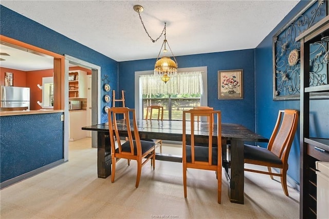 dining area featuring a textured ceiling