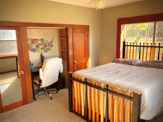 bedroom with ceiling fan, carpet, and multiple windows