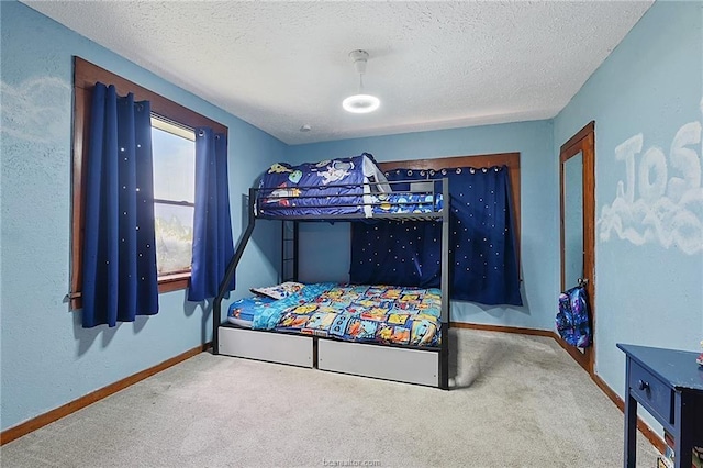 bedroom with a textured ceiling and carpet flooring