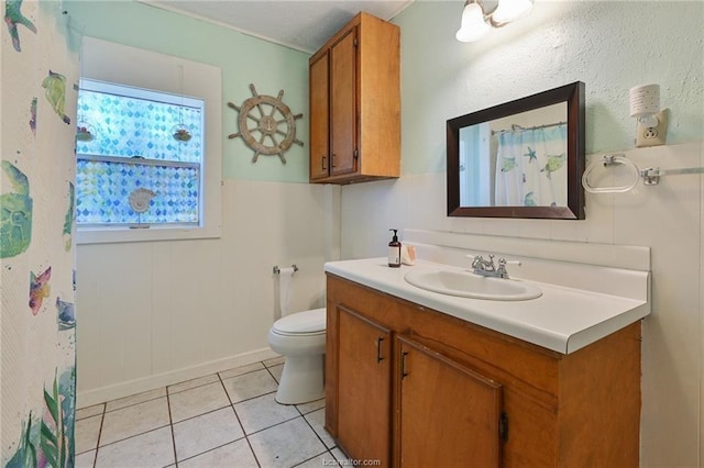 bathroom featuring vanity, toilet, and tile patterned floors